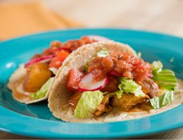 Chile and lime chicken potato tacos on a blue plate
