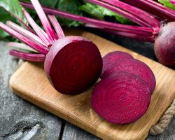 A beet sliced up on a cutting board.