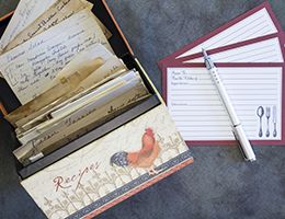 An open recipe box displays handwritten recipe cards.