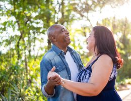 An older couple dancing together outdoors