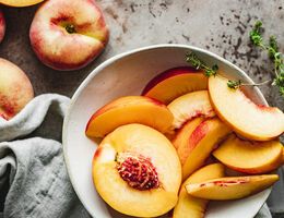 Sliced peaches in a bowl.