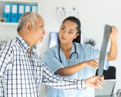 An older man talks to his doctor