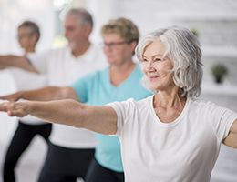 A group of aging adults participating in a tai chi class.