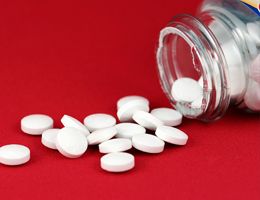 Aspirin spilling out of a bottle