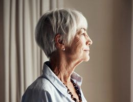 Profile of a woman looking out a window. 