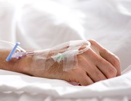 A hand hooked up to an IV.