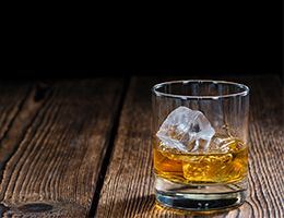 Alcohol and ice in a tumbler.