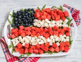 A platter of watermelon, cheese and blueberries arranged like an American flag.