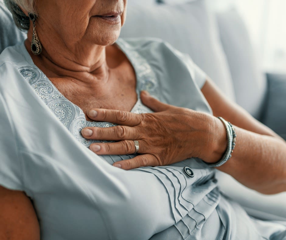 woman touches heart