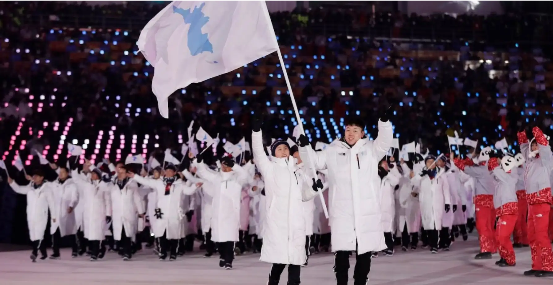 northern and southern koreans marching together at 2000 olympics image