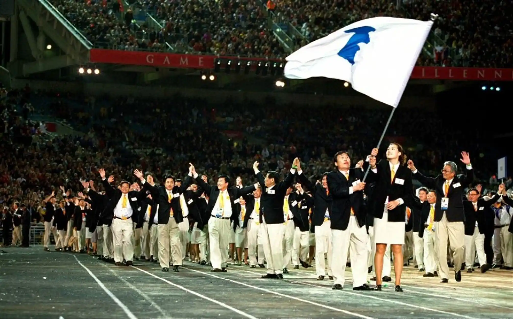 northern and southern koreans marching together at 2000 olympics image