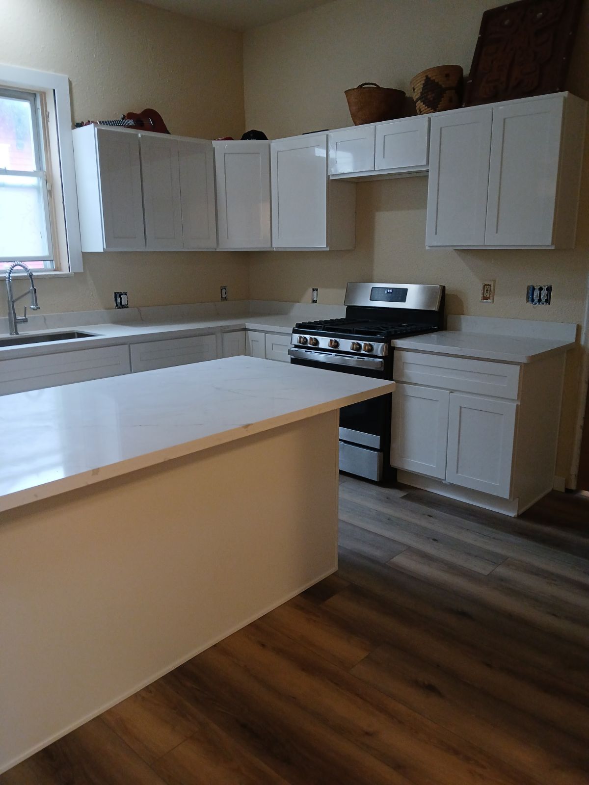 updated kitchen flooring, cabinets, and countertops