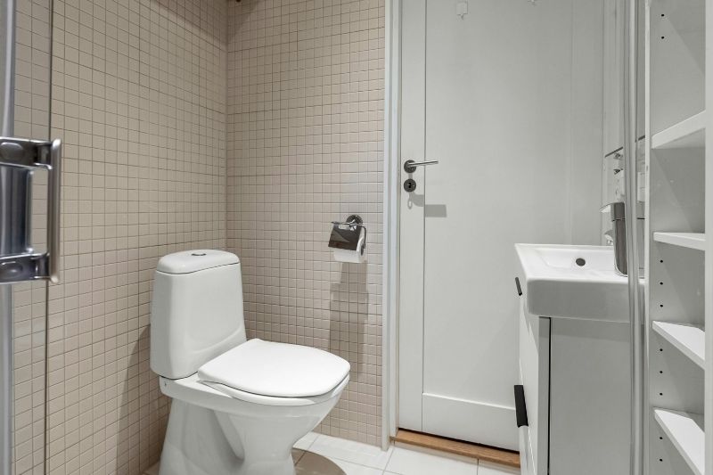 Professional plumber installing a new toilet in a bathroom