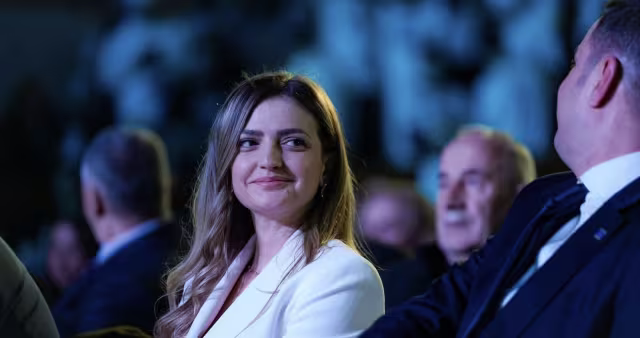 Abdixhiku reads the speech written by his wife, Albina