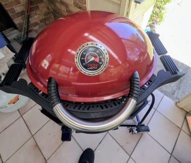 Technician cleaning BBQ