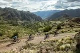a group of cyclists enjoys stunning views during an electric mountain bike tour in the Sacred Valley