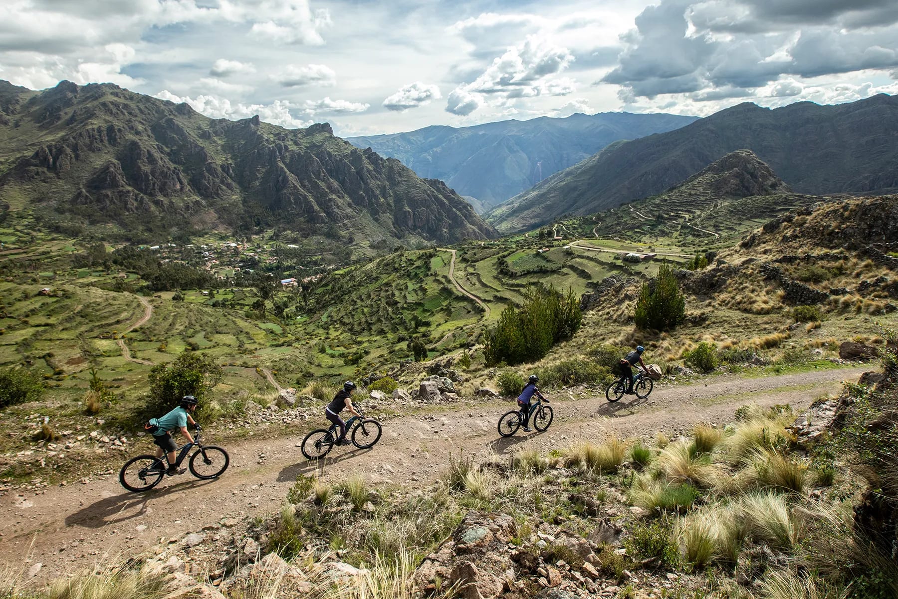 a group of cyclists enjoys stunning views during an electric mountain bike tour in the Sacred Valley