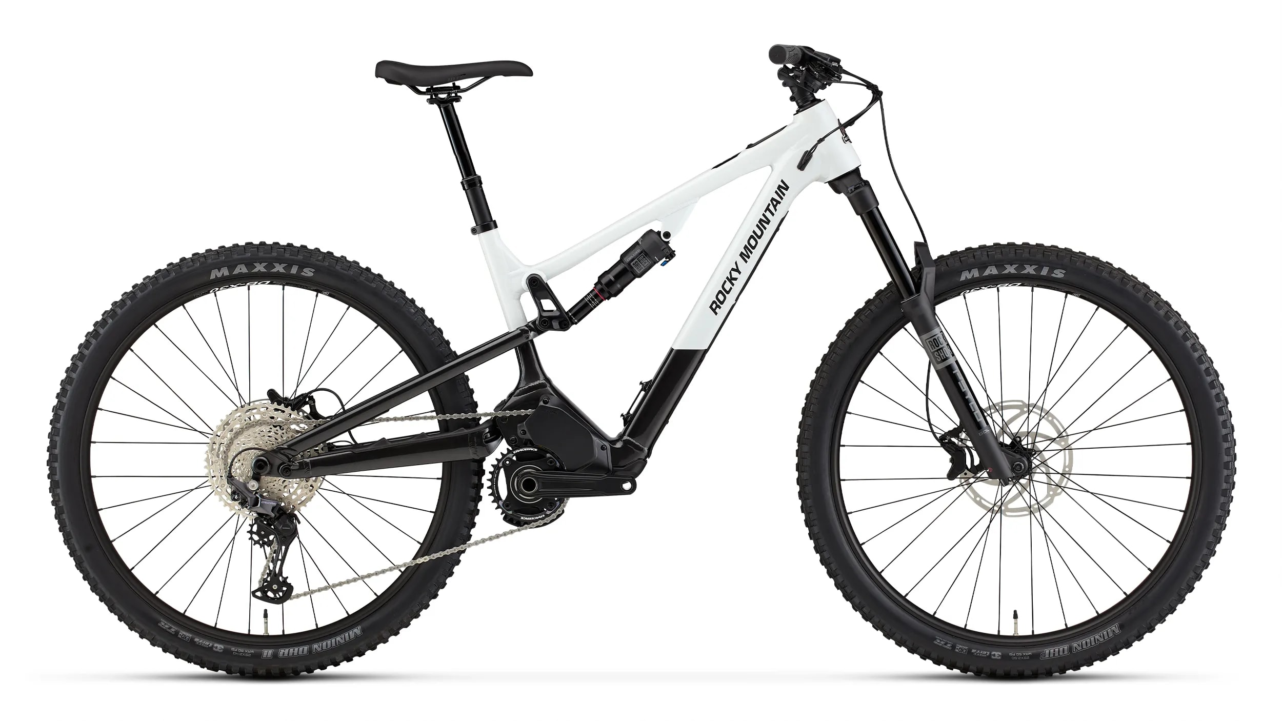 A modern mountain bike with a sleek black and white frame, full suspension, and disc brakes, featuring a battery for electric assistance.