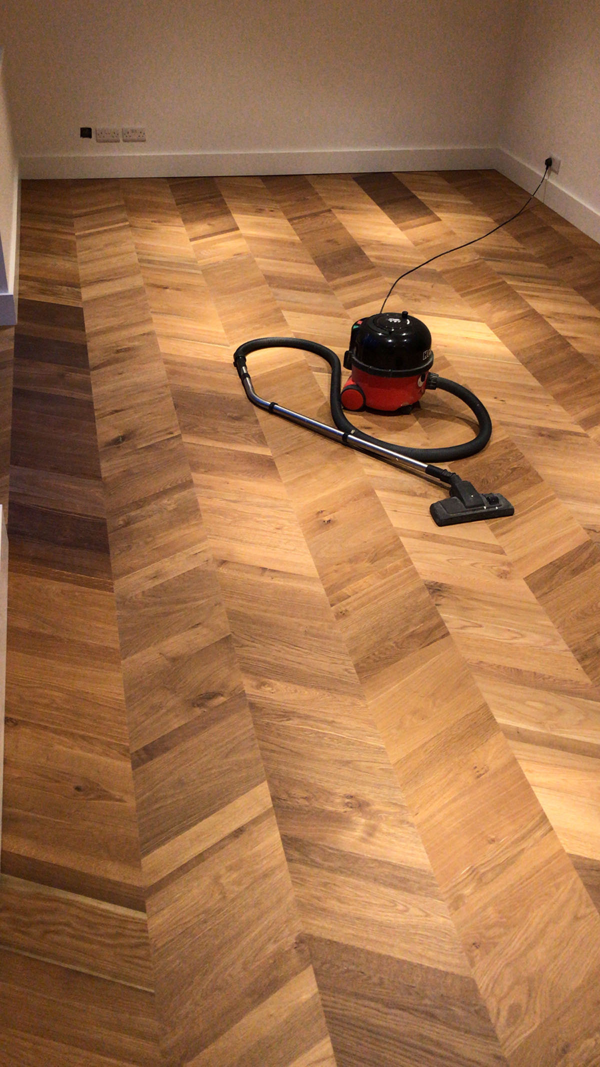 Premium herringbone wood flooring installation in Kenya