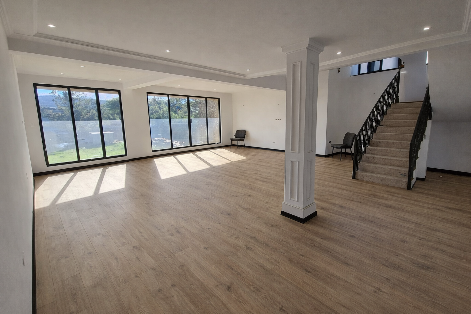 Large luxury bedroom with beautifully installed laminate flooring