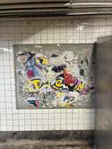 If you get off at East Broadway and exit at Madison Street, you can see a poster for Pokémon: The First Movie, which had its U.S. release in 1999. It was hiding beneath decades worth of other posters pasted on top, which were just removed, revealing this from 26 years ago.