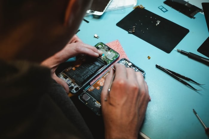 a man repairing mobile phone