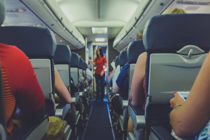 flight attendant asking passengers to switch off their phone