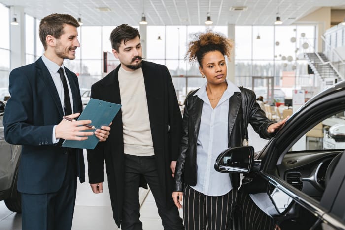 couples checking out a car