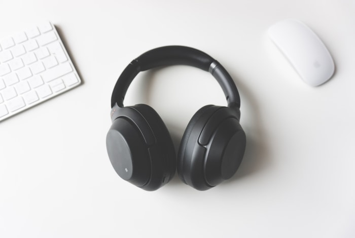 a black colour headphone in a white colour table