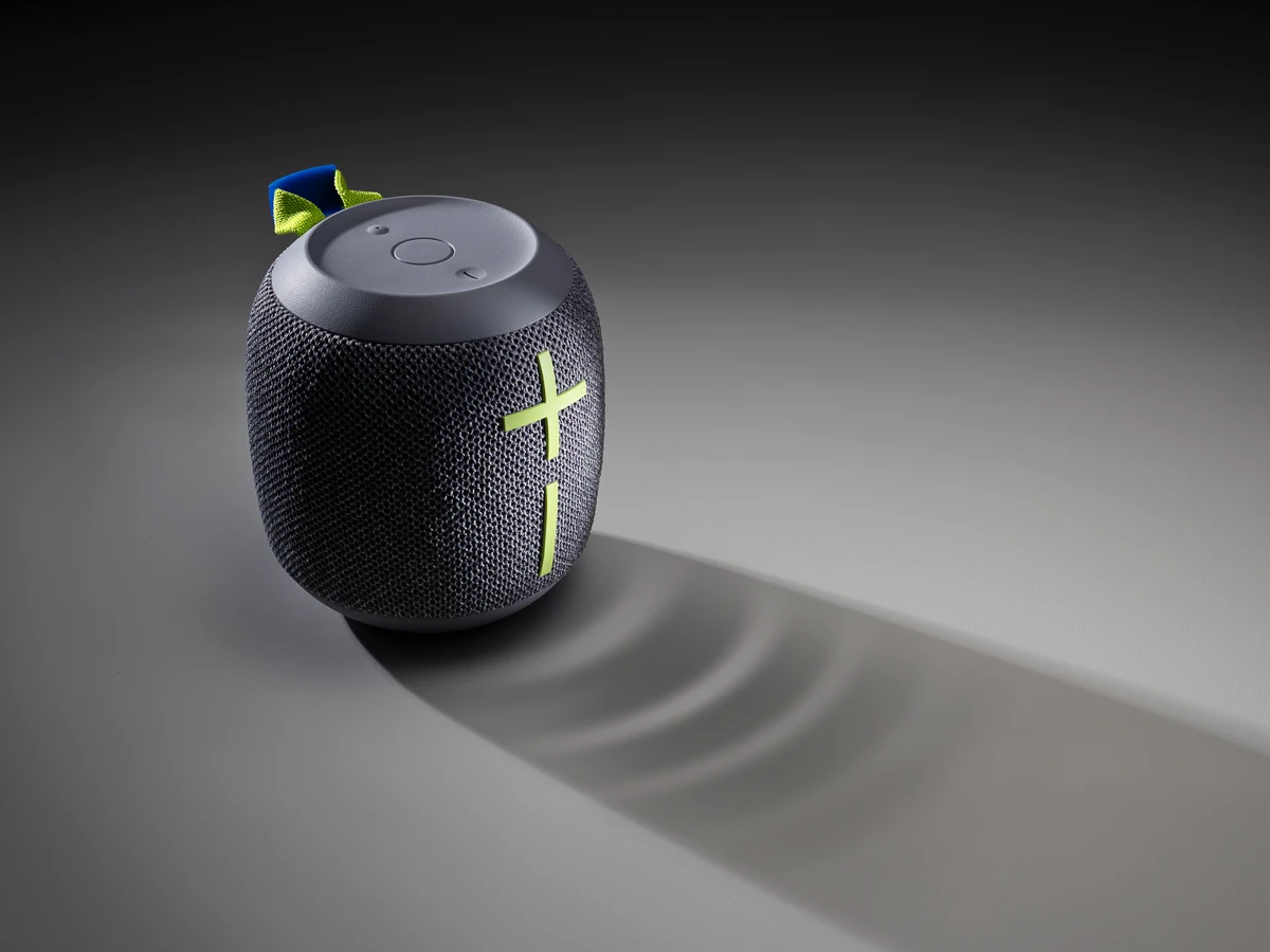 a portable speaker showing sound wave vibration on the surface its sitting on