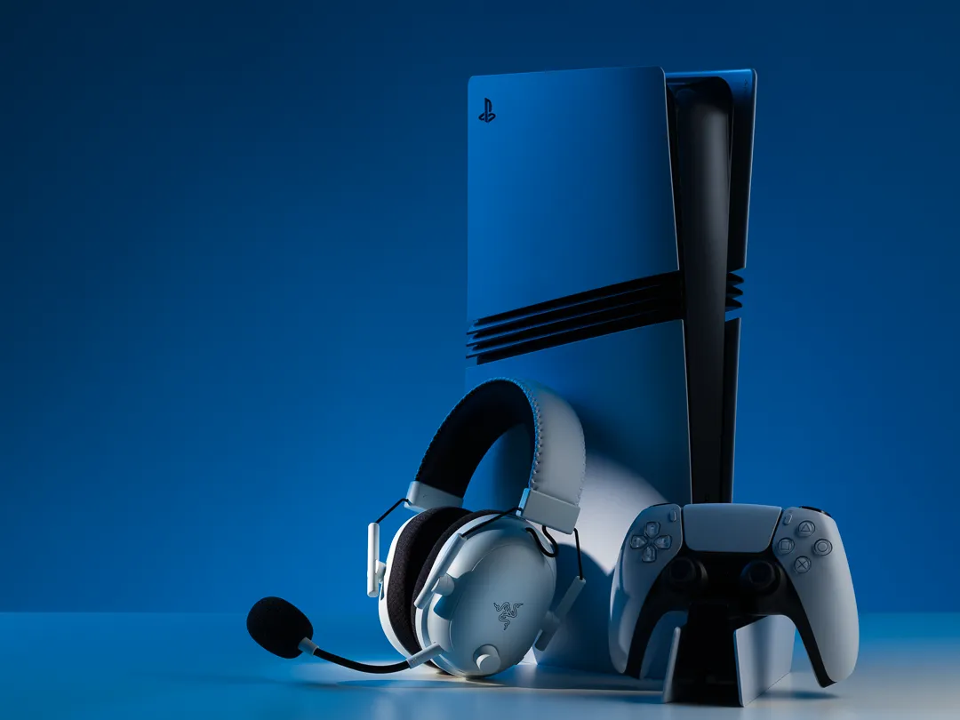 Razer Blackshark V2 Pro sitting against a Playstation 5 Pro with a blue background