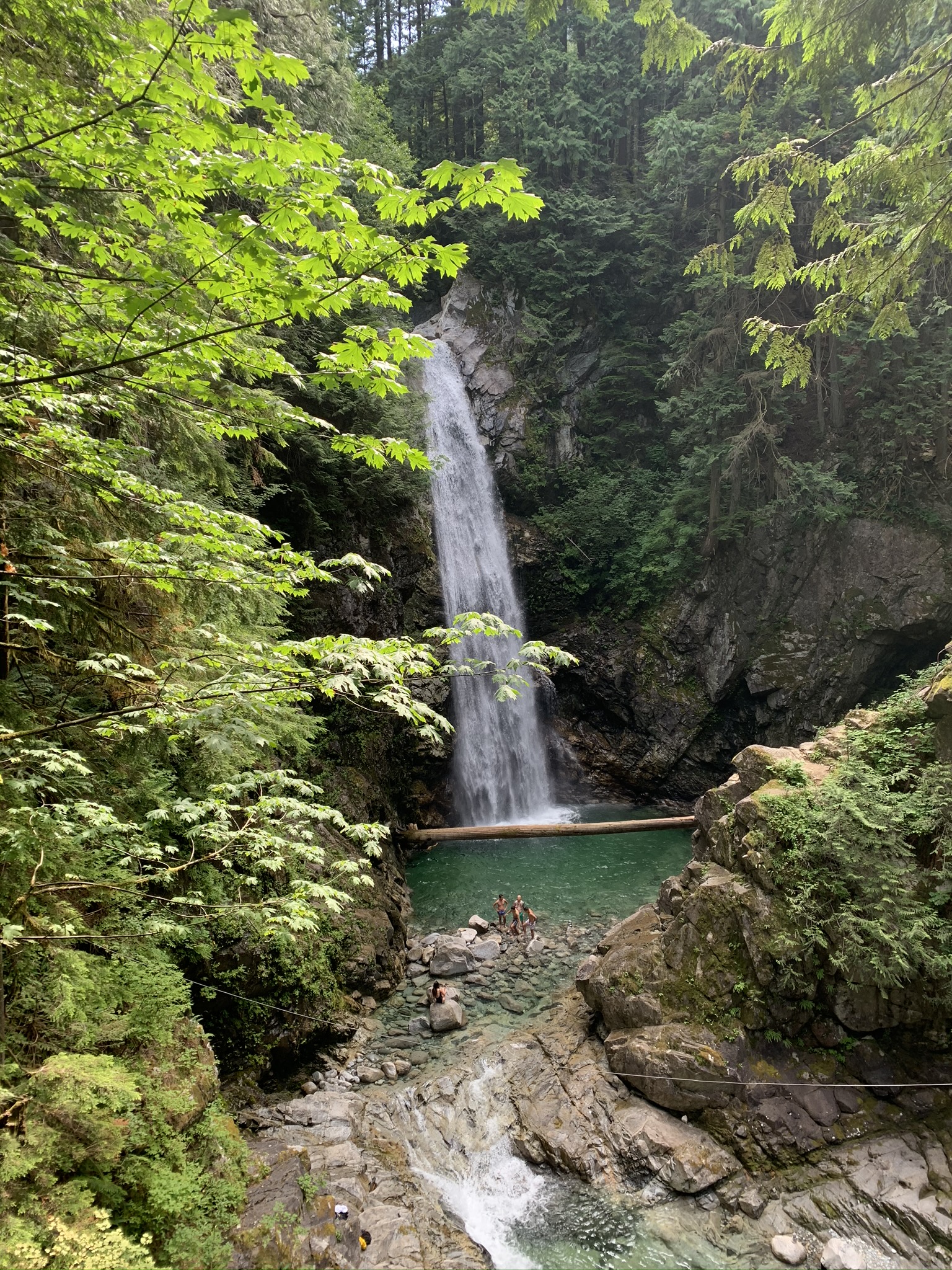 Shot of Cascade Falls from the suspension bridge with people at the base