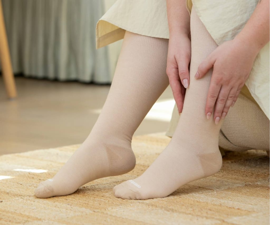 Woman wearing beige bamboo compression socks