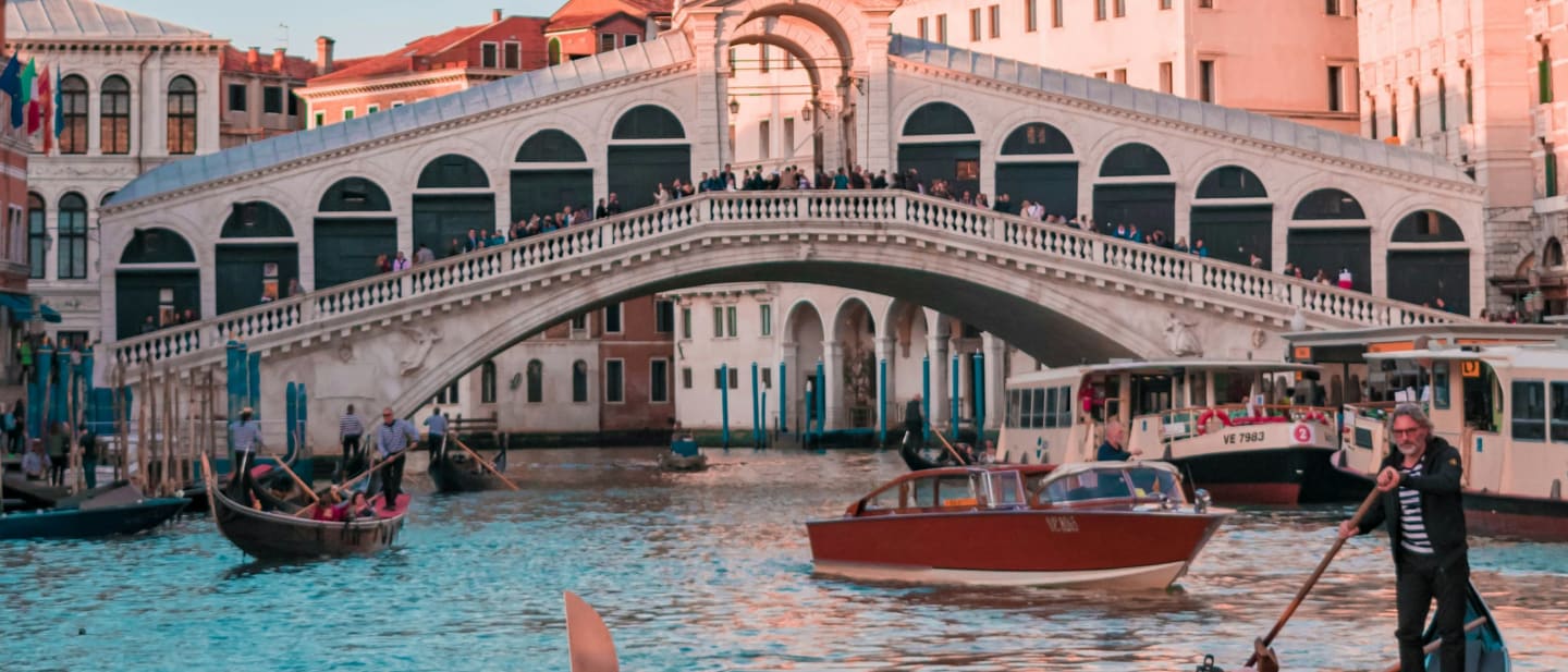 Boats passing under the Rialto bridge on the Grand Canal in Venice