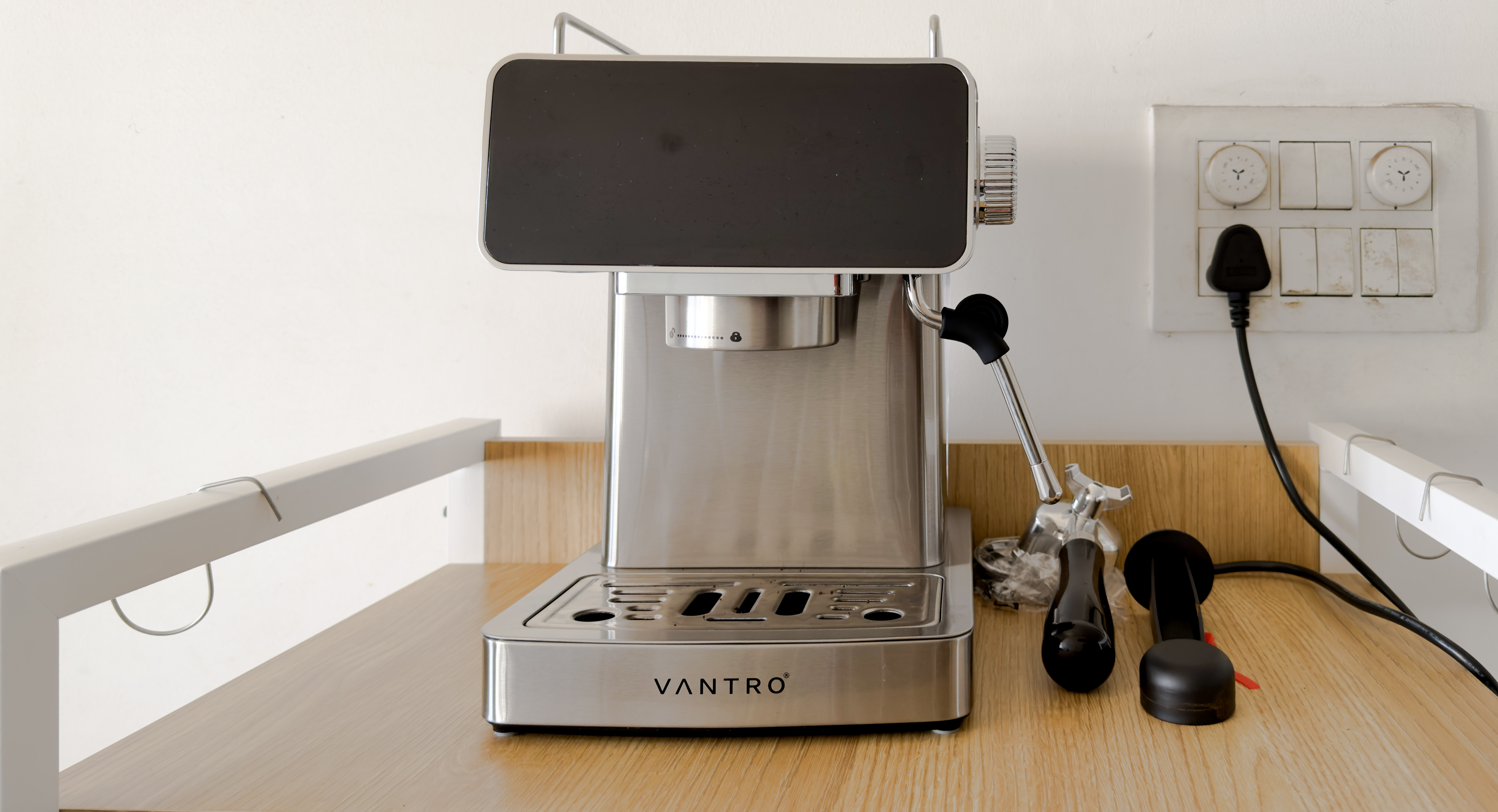 The VANTRO espresso machine on the top shelf of the new coffee stand, with its portafilter and tamper beside it
