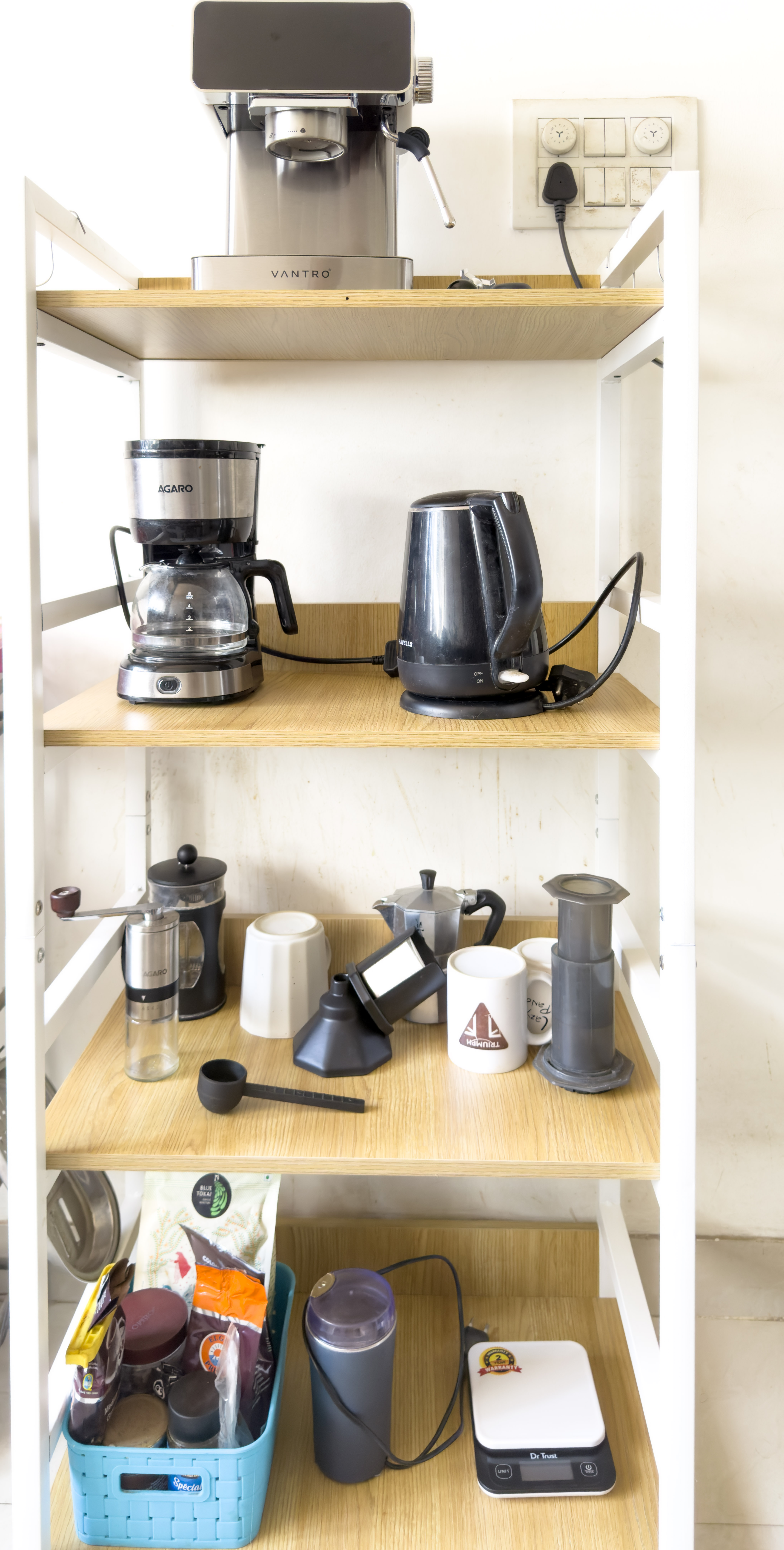 The coffee stand in the kitchen, with the VANTRO espresso machine on top, the drip machine and kettle below, and the French press, Moka pot and AeroPress on the shelf under that