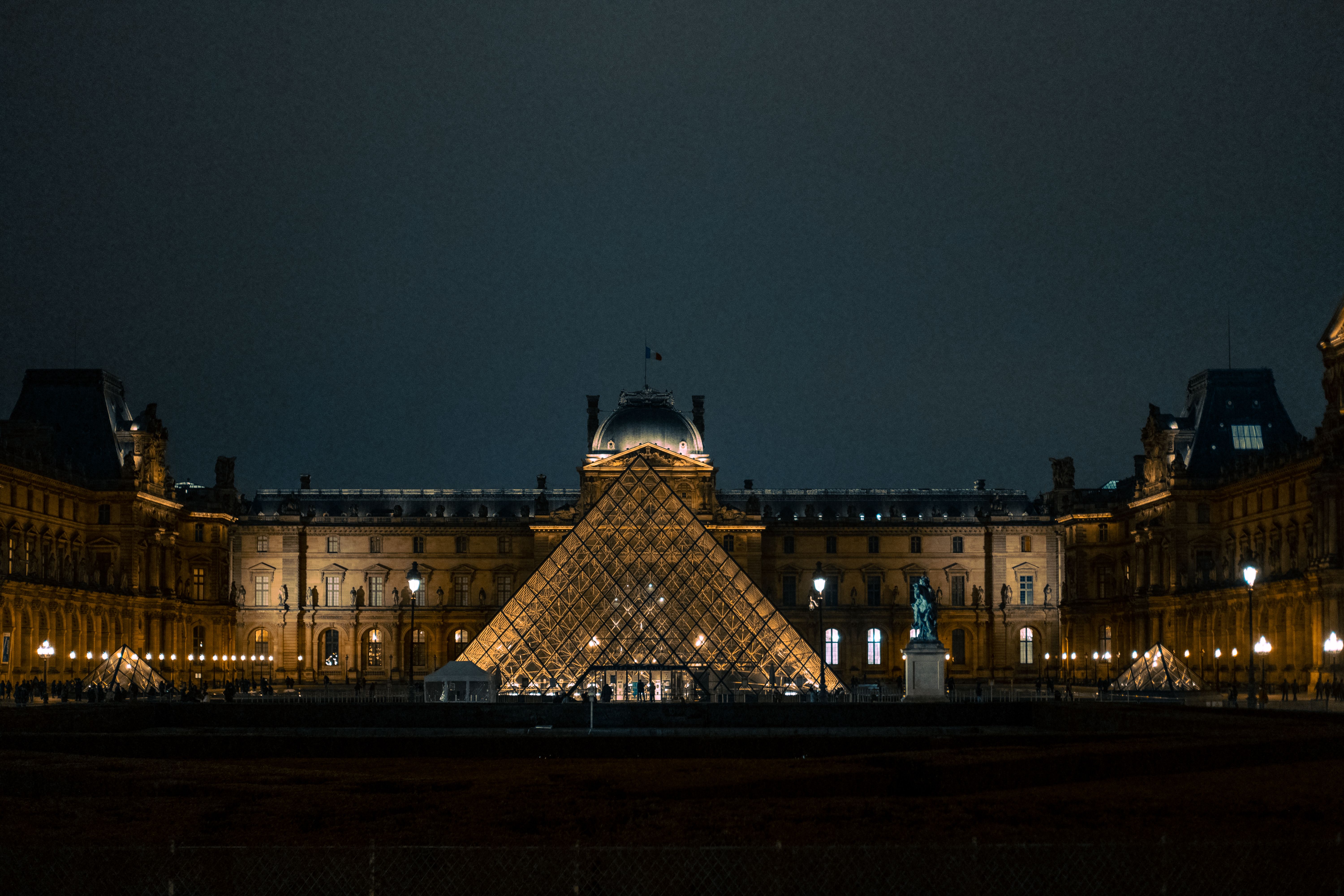 The Louvre pyramid lit up at night