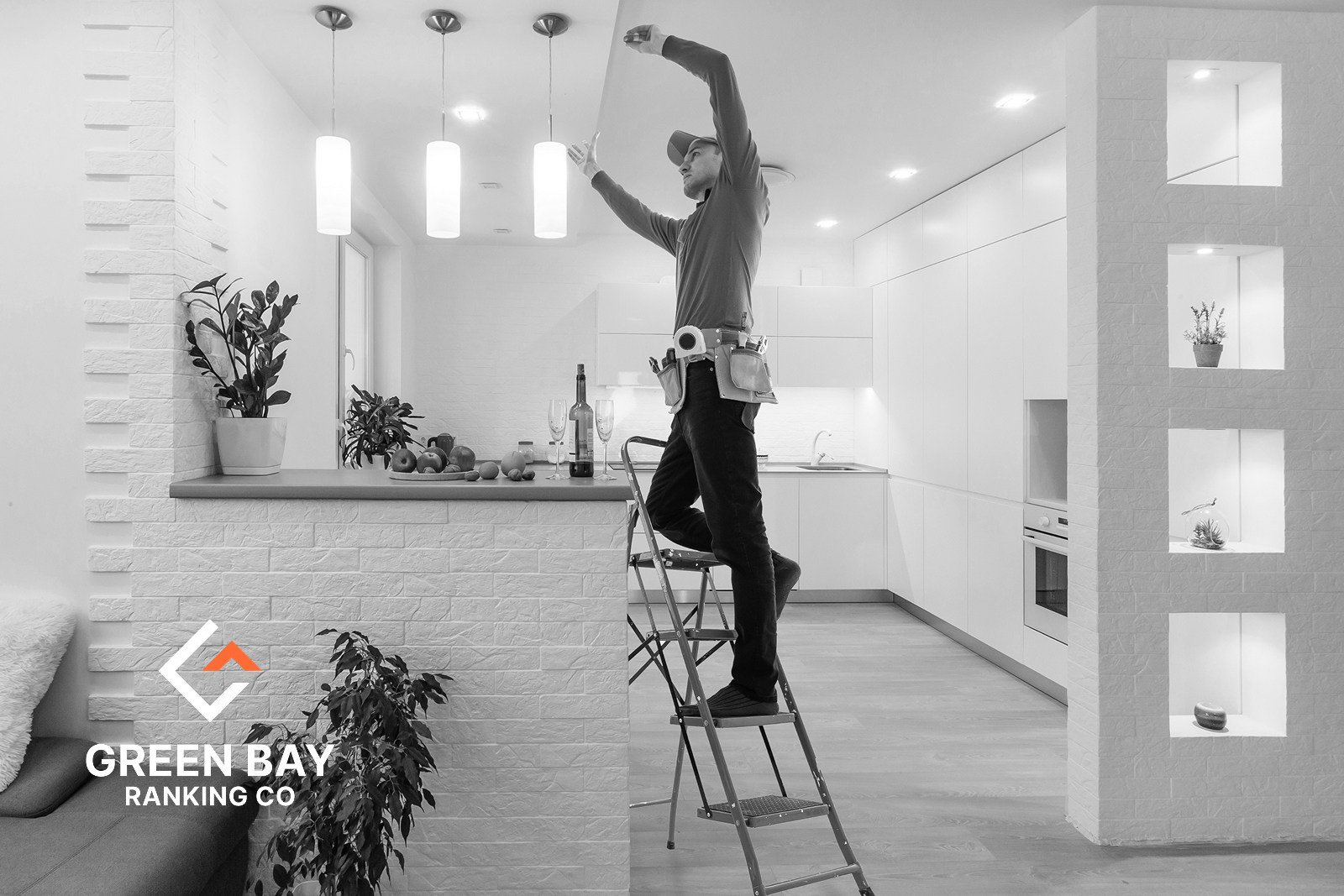 Electrician installing modern kitchen ceiling lighting in a residential home in Green Bay, WI.