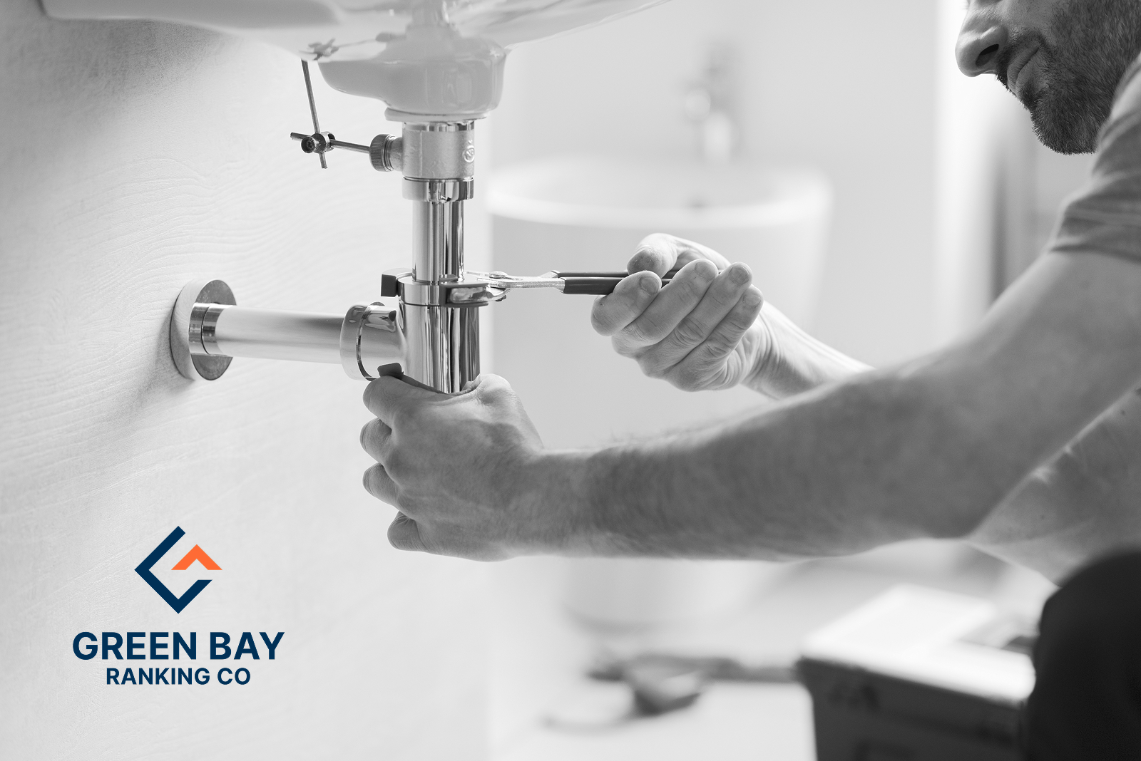 Plumber tightening sink drain pipes for a local plumbing business in Green Bay, Wisconsin.