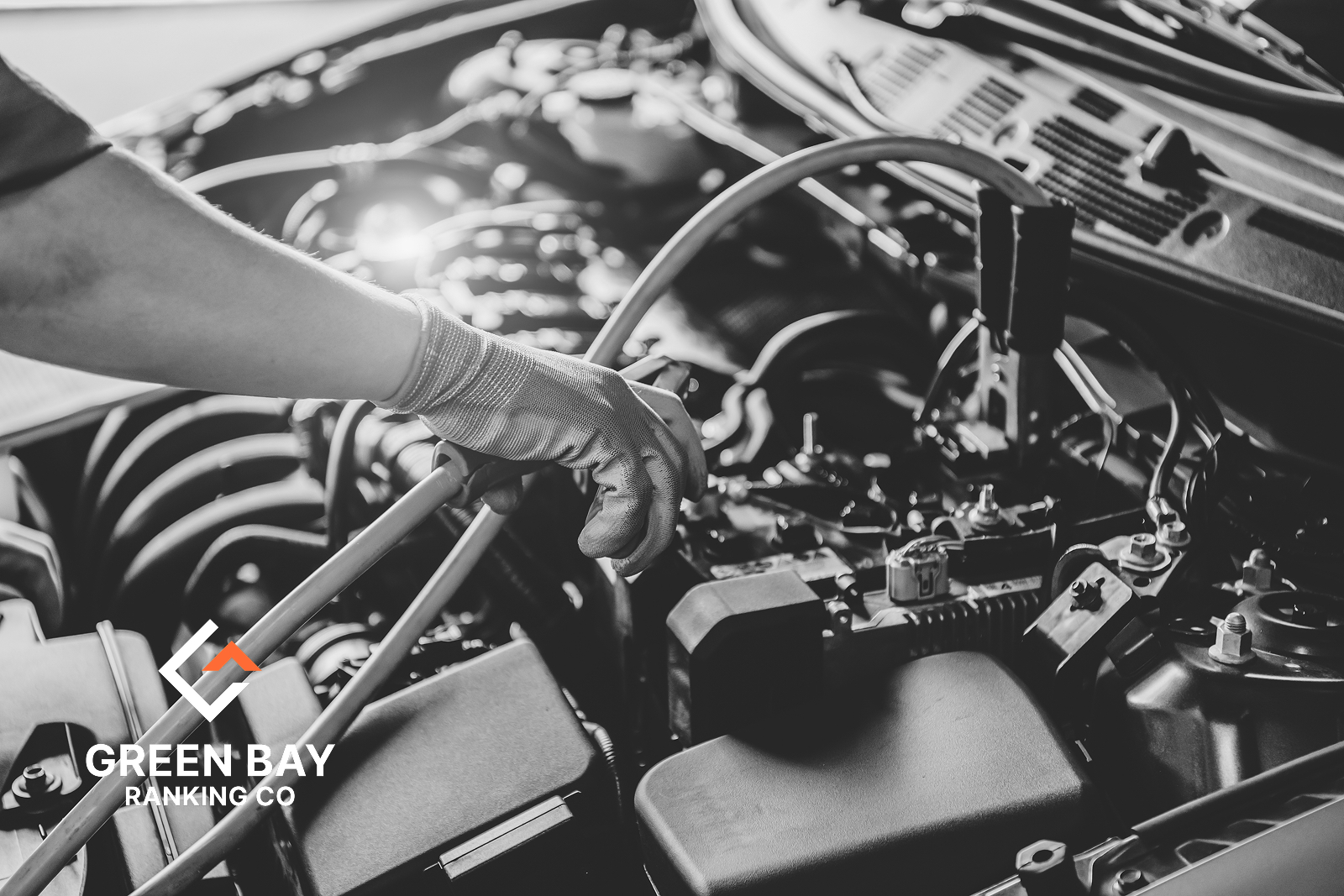 Auto repair technician servicing a vehicle engine at a local auto repair shop in Green Bay, Wisconsin.
