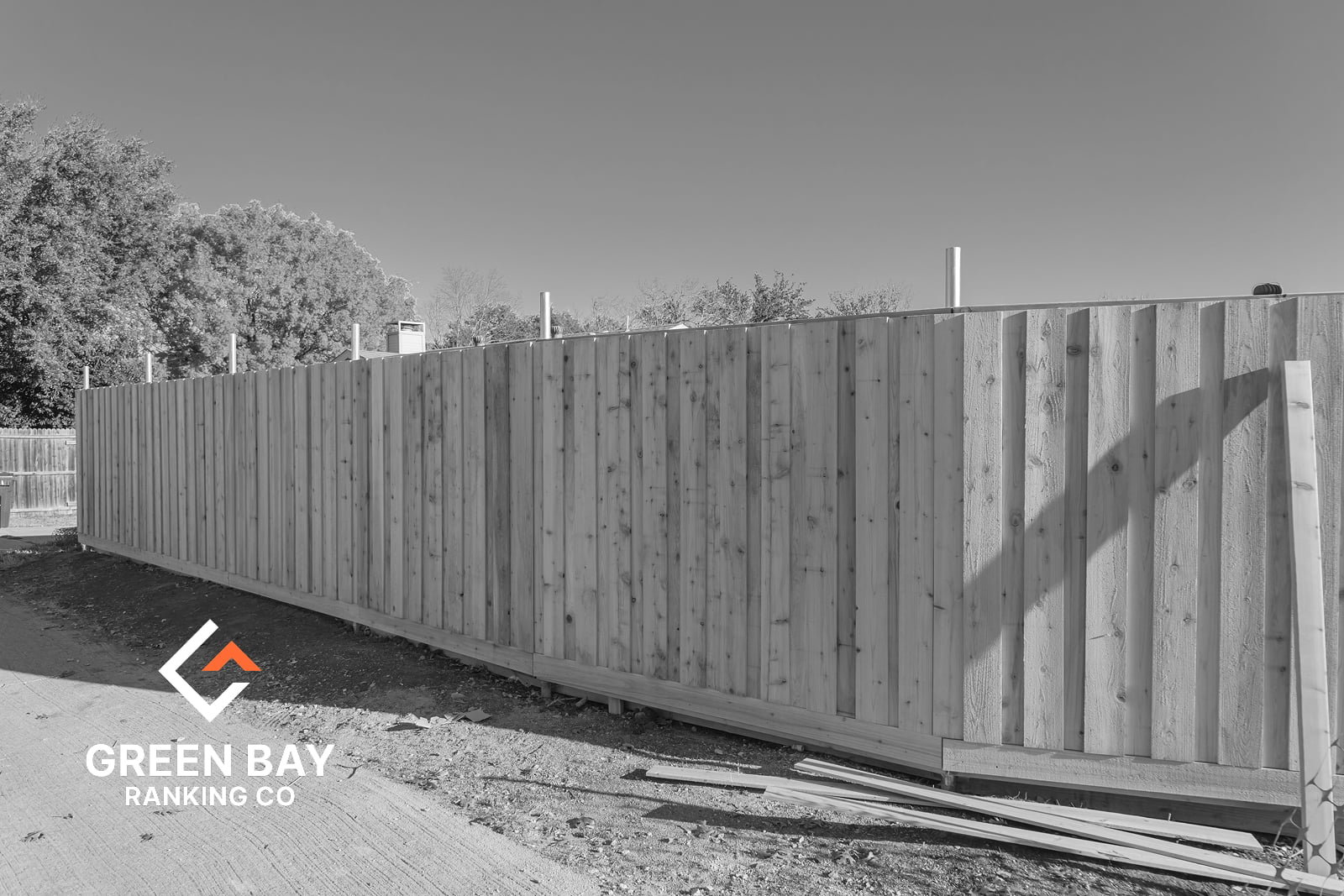 Newly installed wood privacy fence with vertical panels at a residential property in Green Bay, WI.