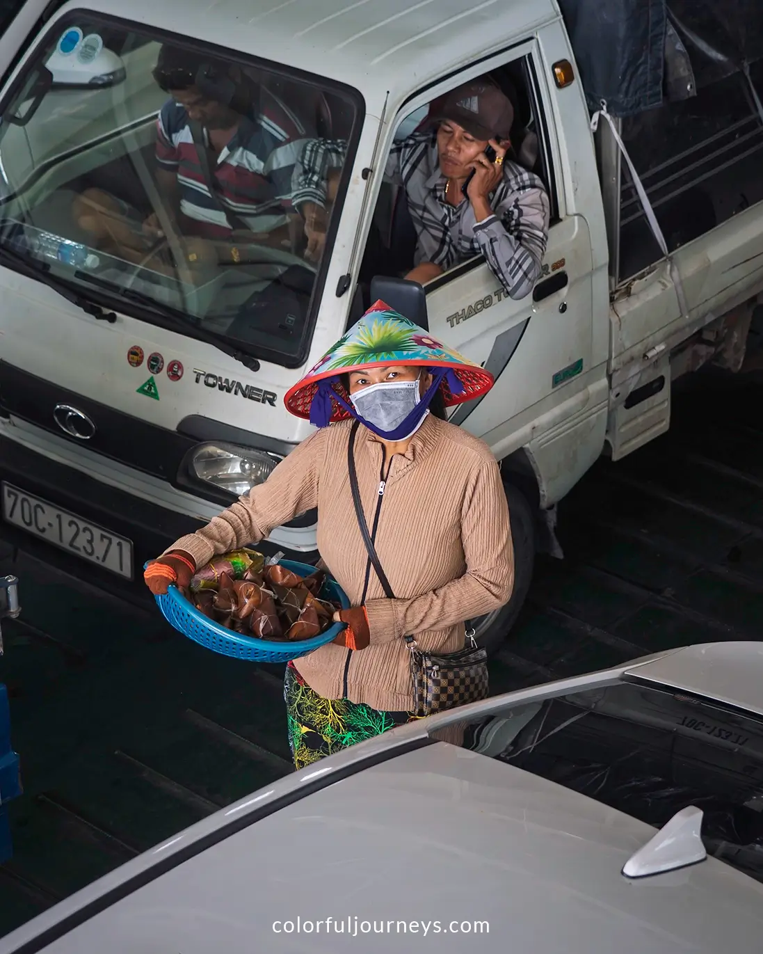 A woman sells fruit on the ferry to Vinh Long, Vietnam