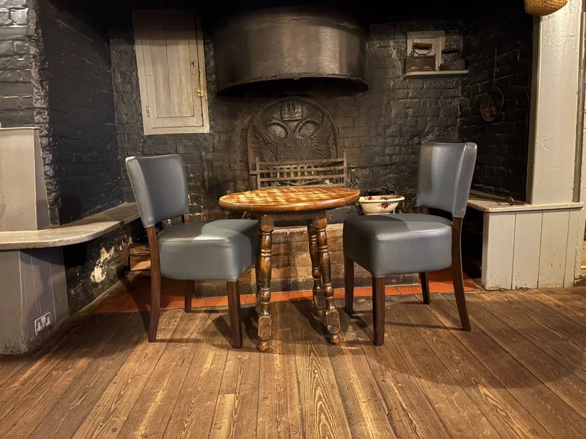 Cosy fireside corner inside the Rose & Crown traditional pub in Mayfield