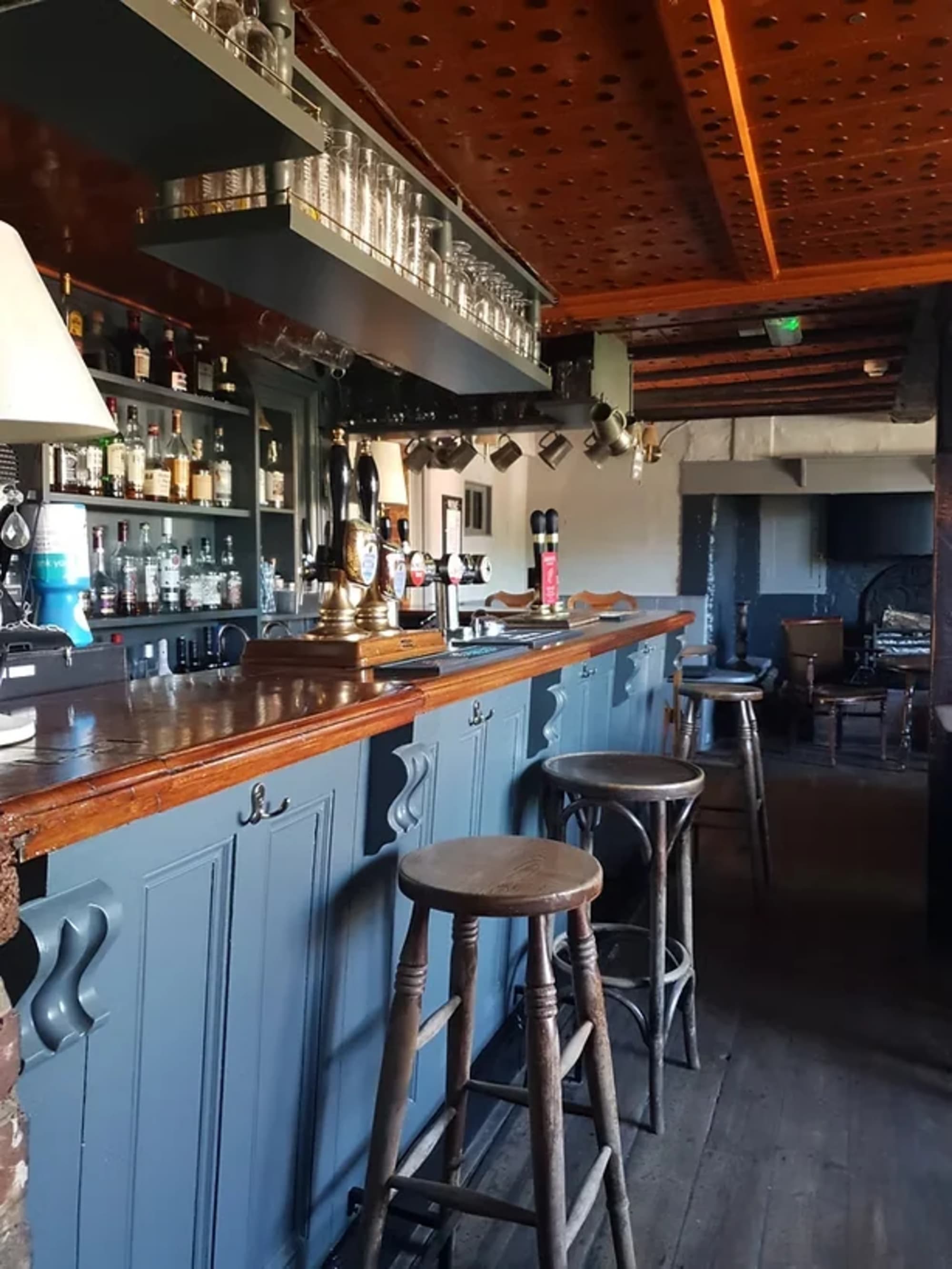 The bar at the Rose & Crown, Mayfield, with ale pumps and a wood-topped counter