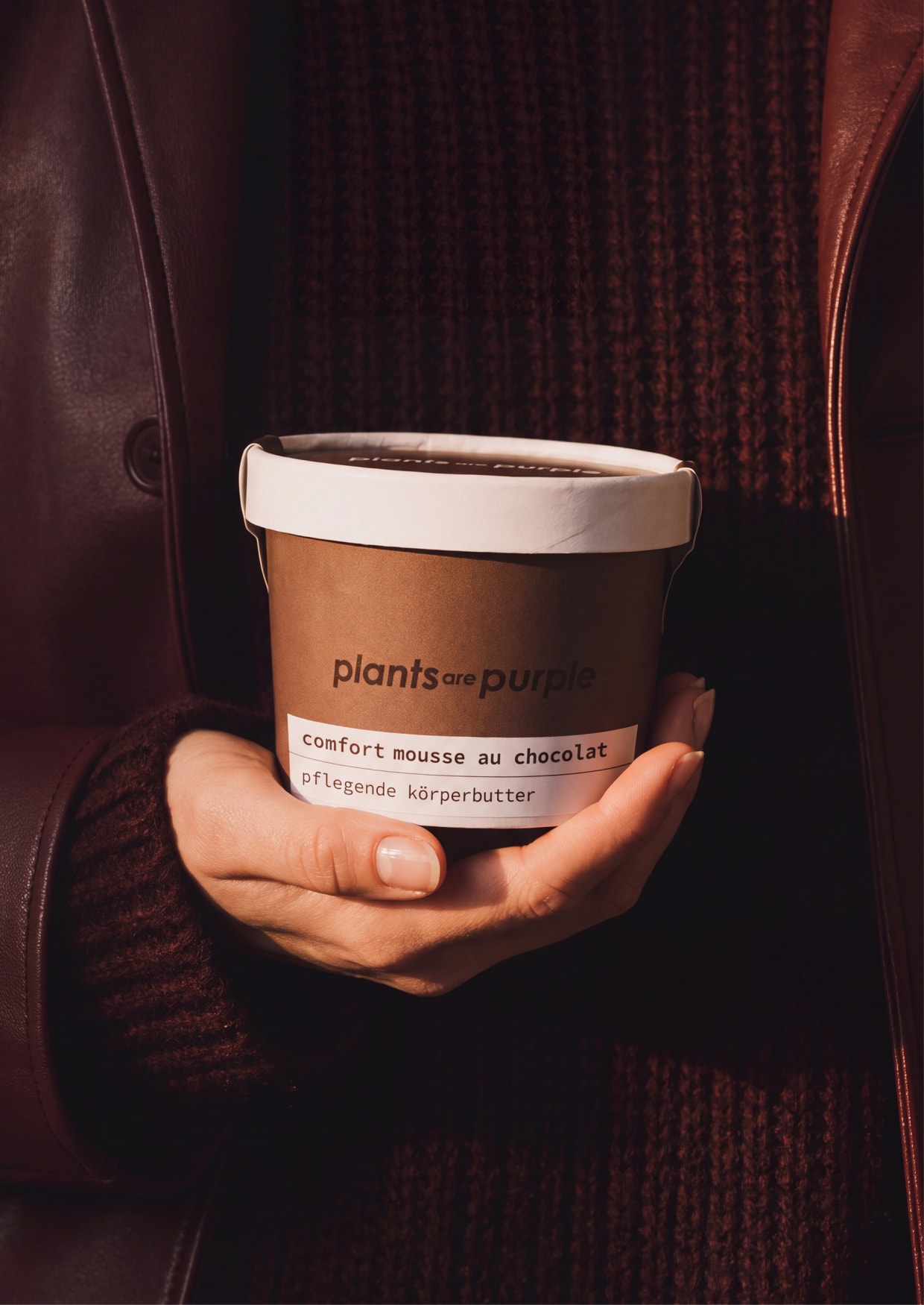 Comfort Mousse au Chocolat held in two hands, with a brown knitted jumper