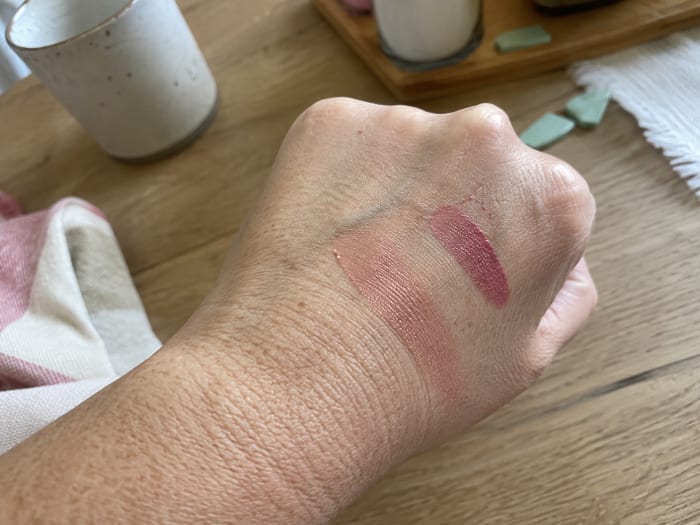Two colour swatches on the back of a hand, one of them half blended in