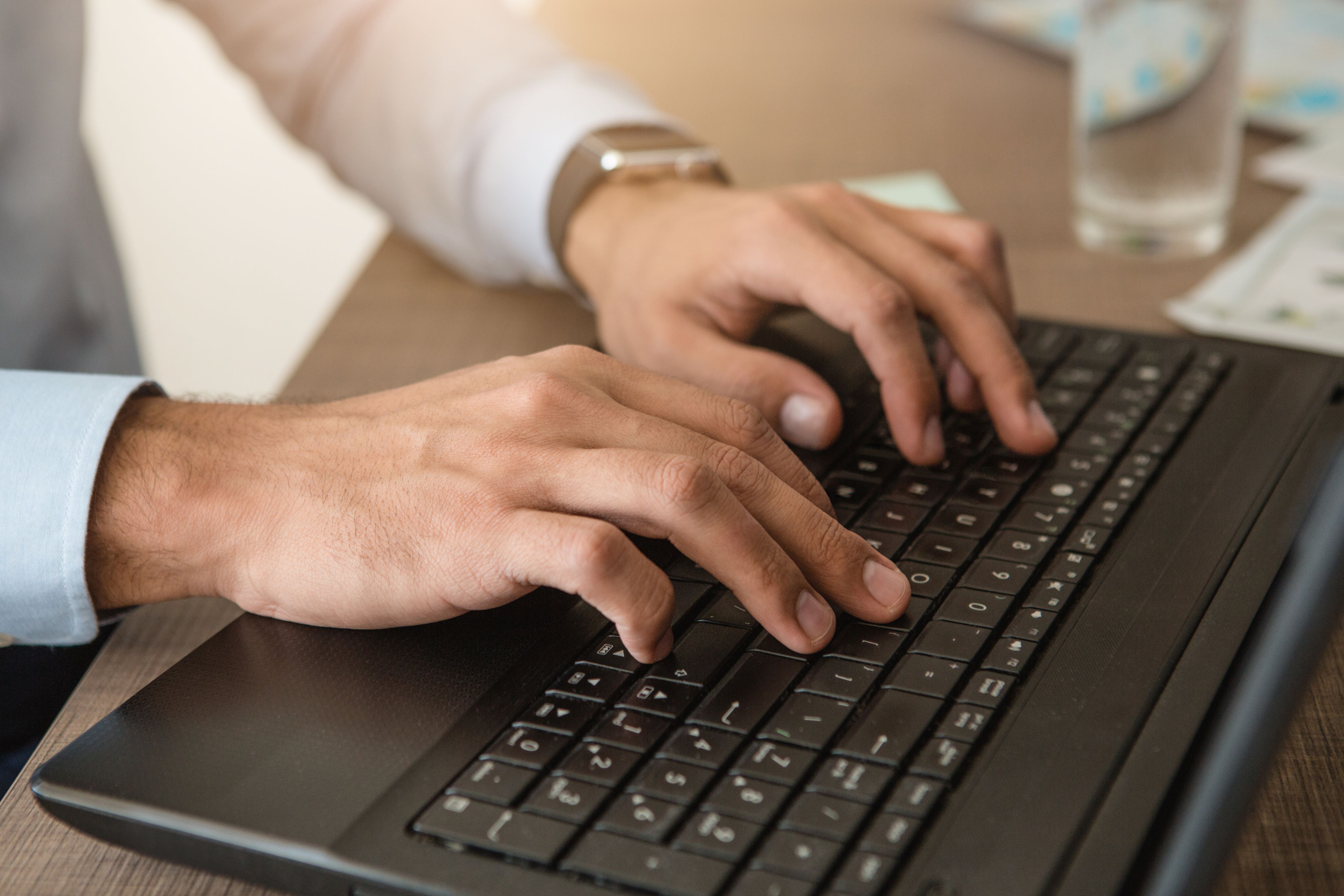 Someone typing on their laptop