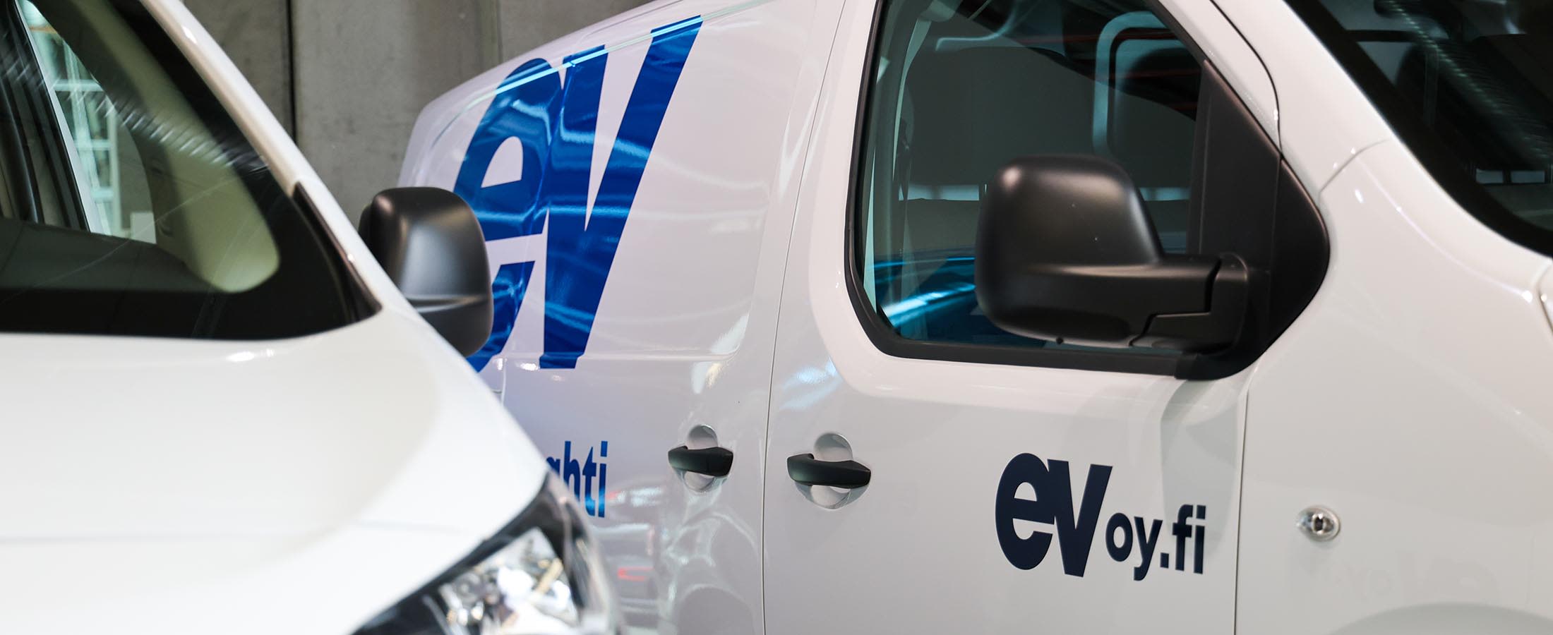 Teippaukset Energiavahdin valkoisten pakettiautojen kyljessä ja etuovessa
