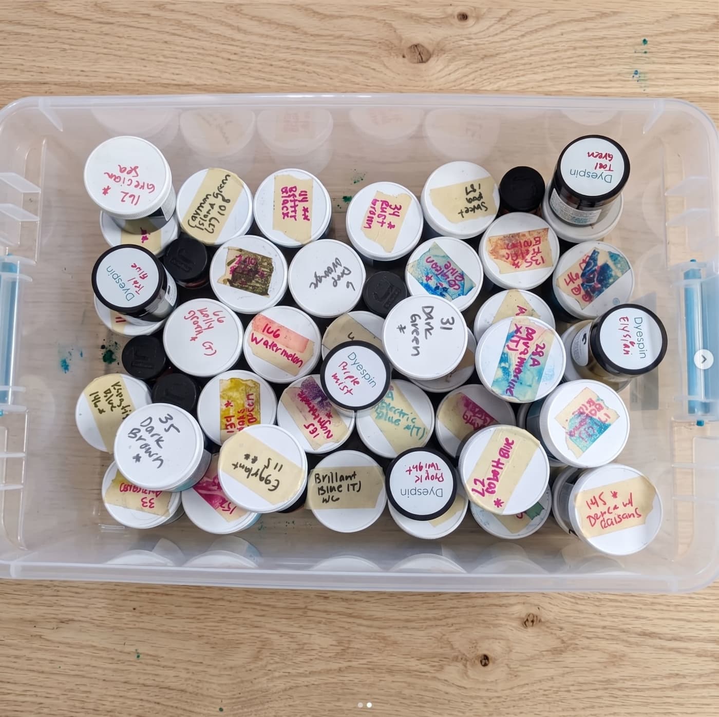 A tub of hand-labelled dye canisters.