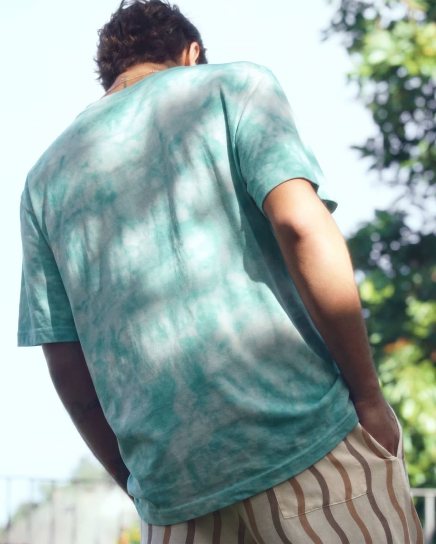 The heavyweight tee, close — the ice-dye break across the back.